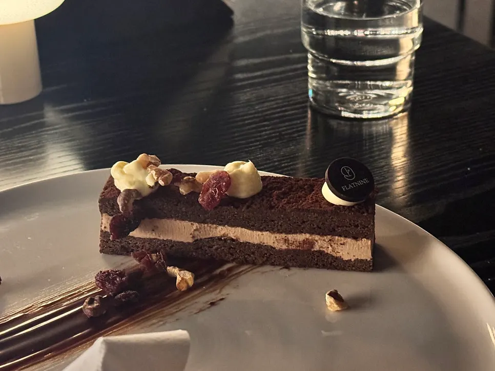 A spoonful of tiramisu dusted with cocoa powder
