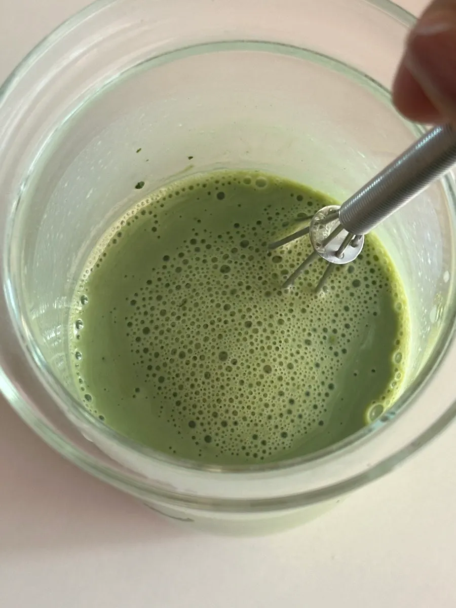 Curly kale powder mixed into water for a morning drink