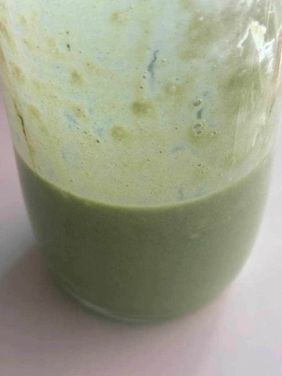 Deep green drink made with curly kale powder