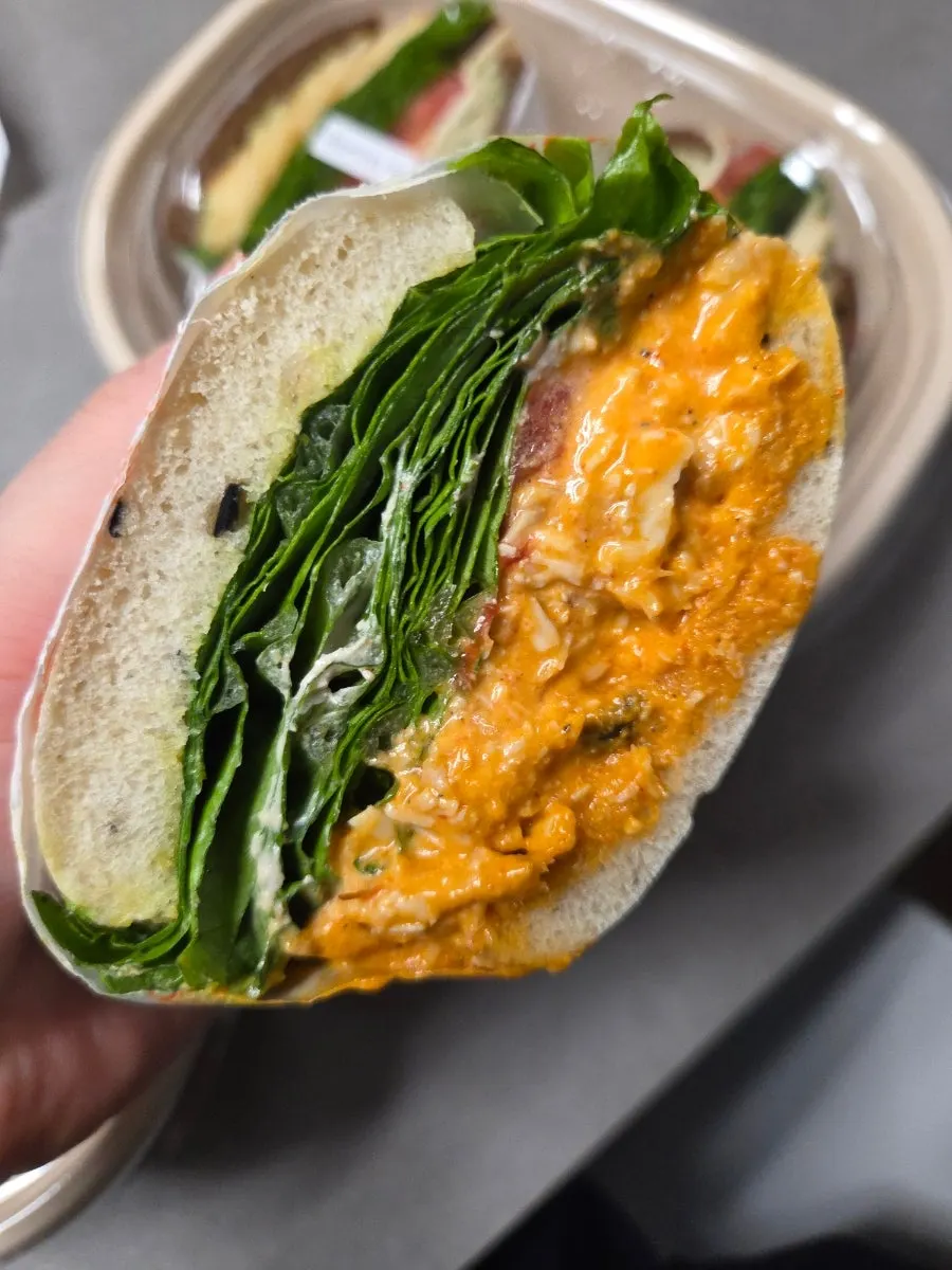 Close-up of the spice chicken chiabatta with sauce dripping