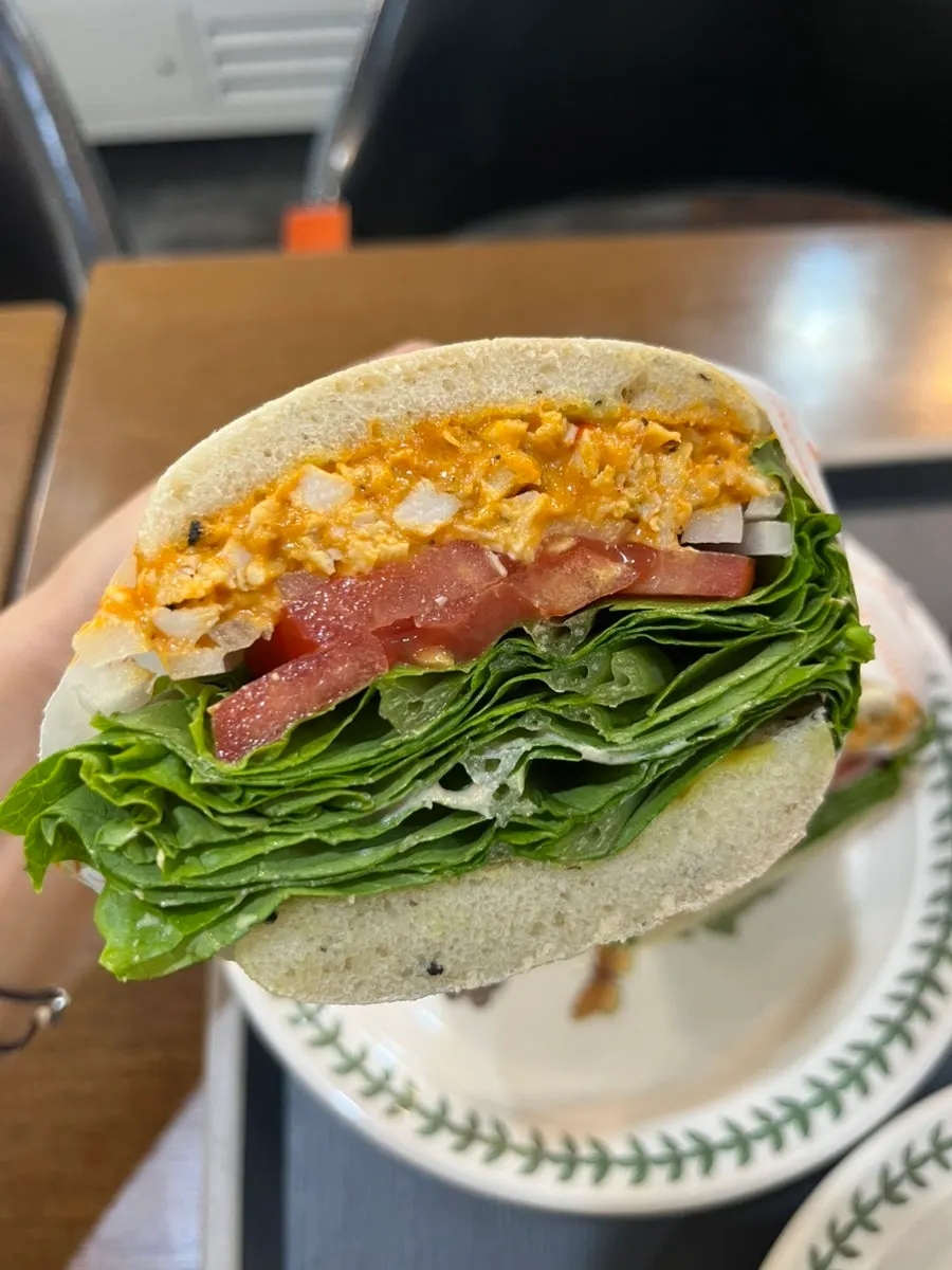 A bite taken out of the basil chicken apple bun