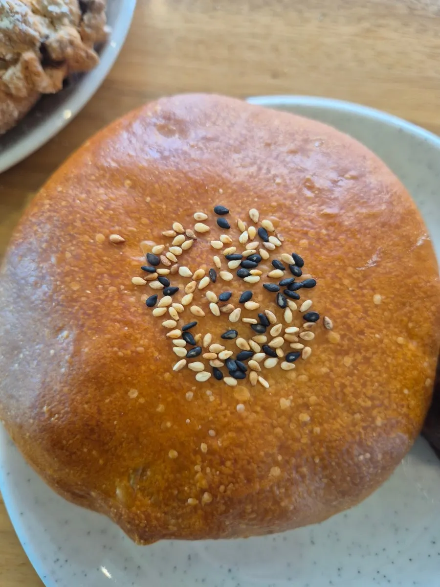 Cross-section of a walnut cream cheese bread cut in half