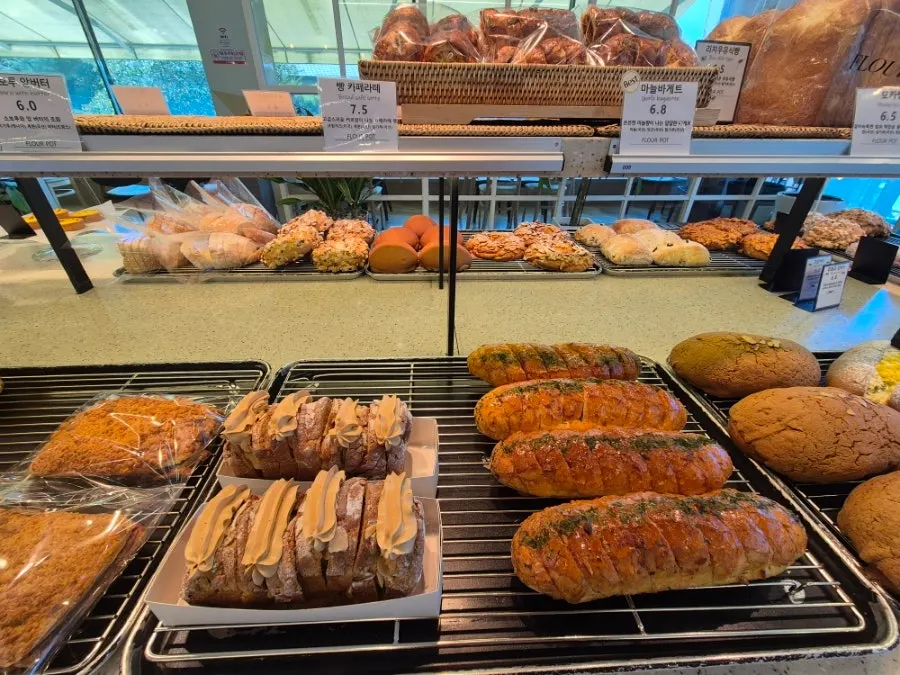 A bakery counter packed with bread at Flowerpot