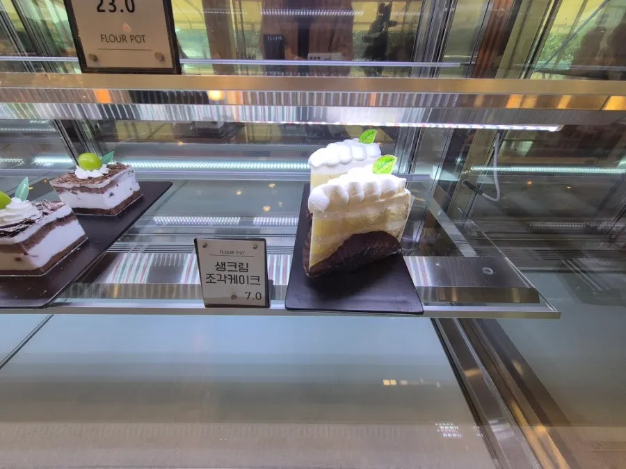 Slice cakes inside the refrigerated display case