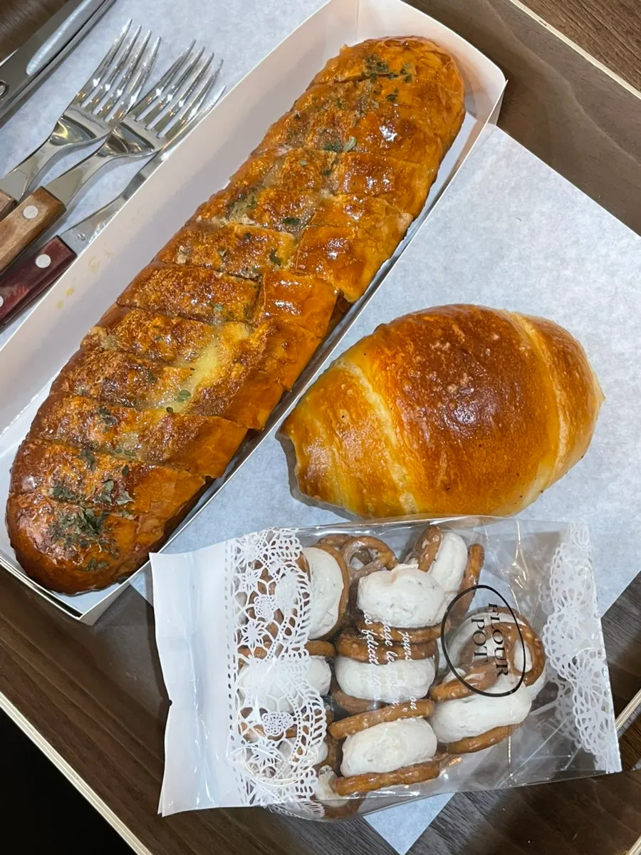 Salt bread, garlic baguette, and meringue cookies plated together