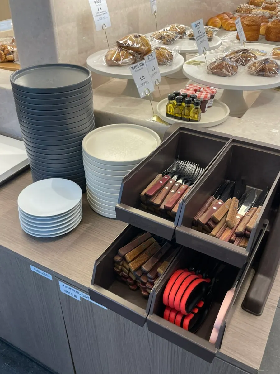 Bowls, forks, and knives set out for bread