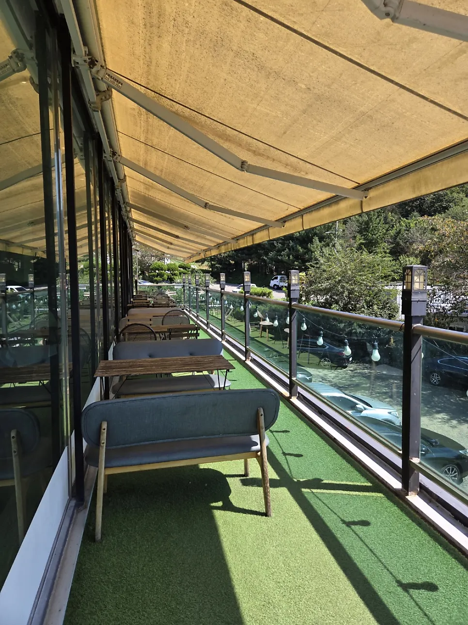 Shaded terrace seating on the second floor of Flowerpot Cafe