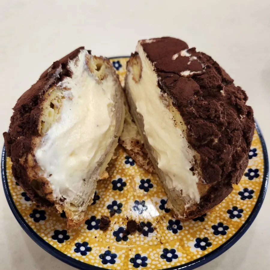 Tiramisu choux dusted with cocoa powder