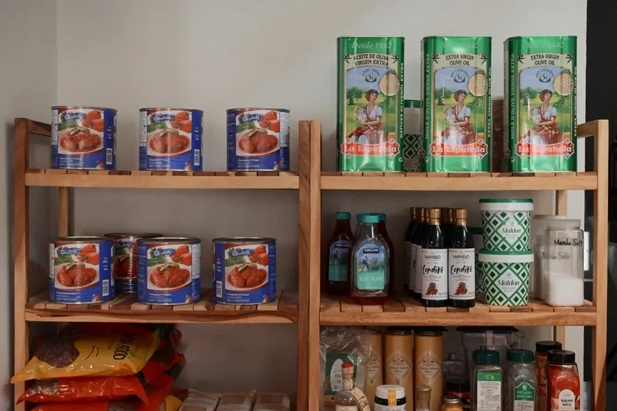 Shelf displaying olive oil and spices