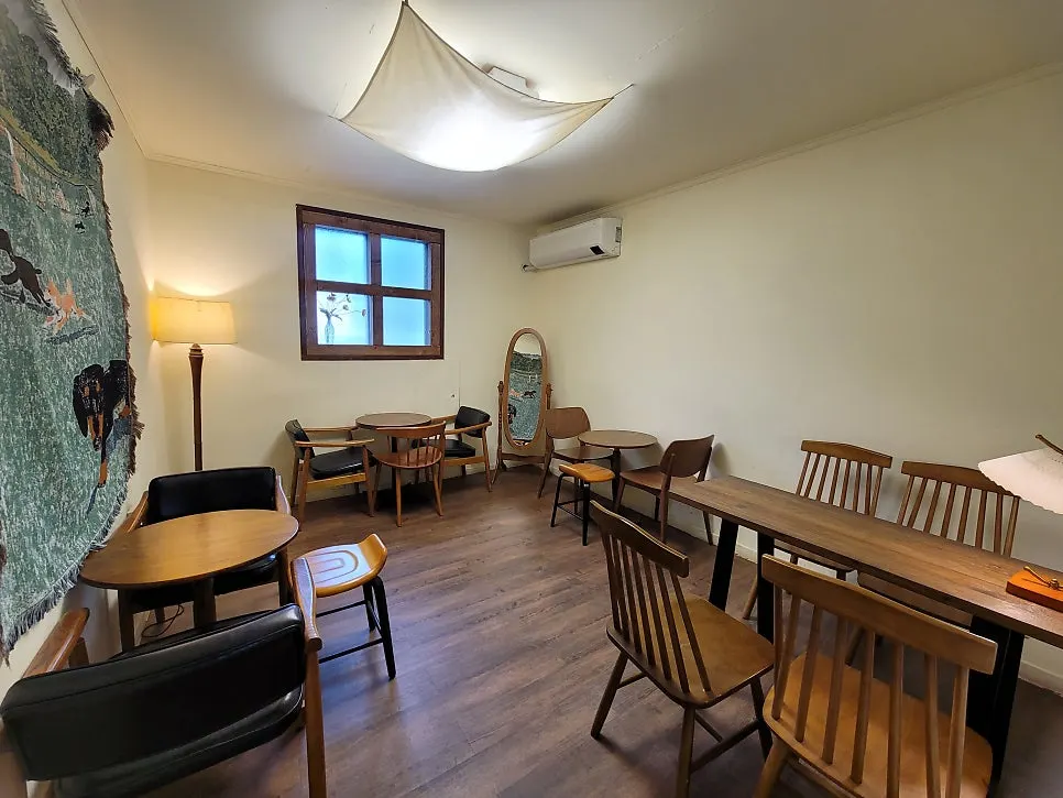 Seating with a large picture window showing greenery outside