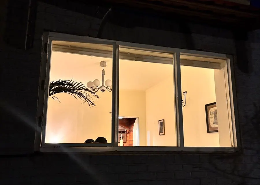 Outdoor artwork under dark, rainy skies