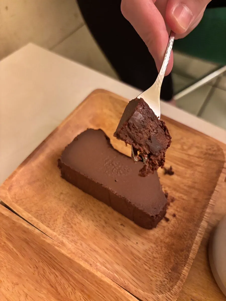 Cross-section of chocolate Basque cheesecake cut with a fork