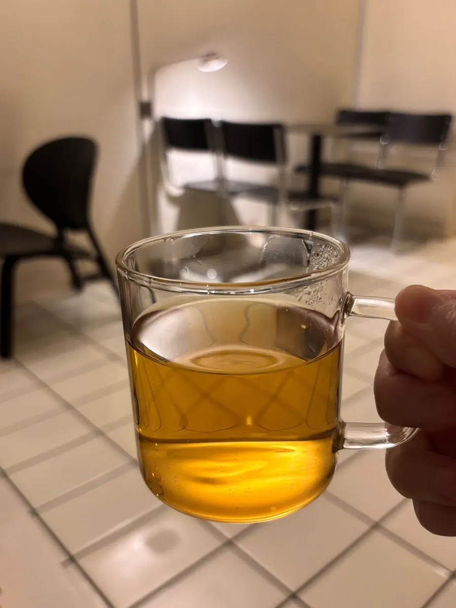 A cup of hot tea served alongside the cake