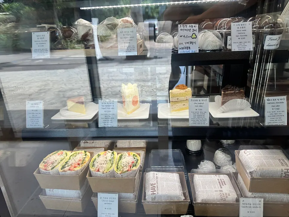 Forest Jeongbang menu board listing coffee, fruit juices, and desserts