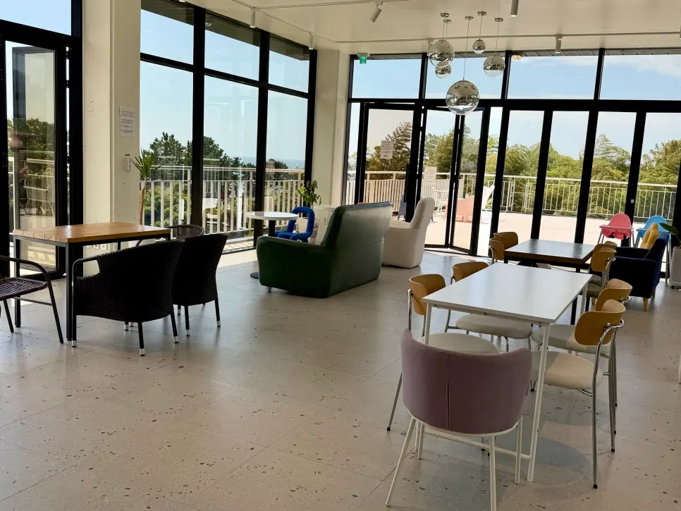 Seat with a view of the Seogwipo sea beyond the second-floor windows