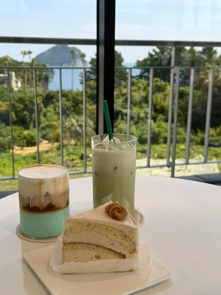 Stirring the Jeongbang Waterfall Latte with a straw
