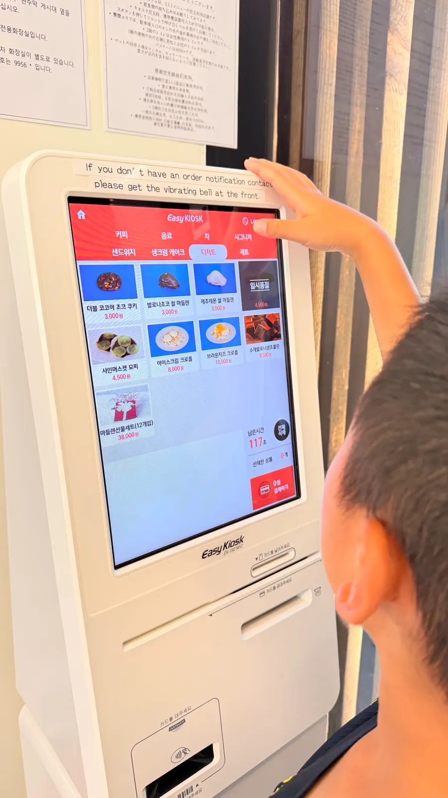 A child looking at the Pokémon plush toys