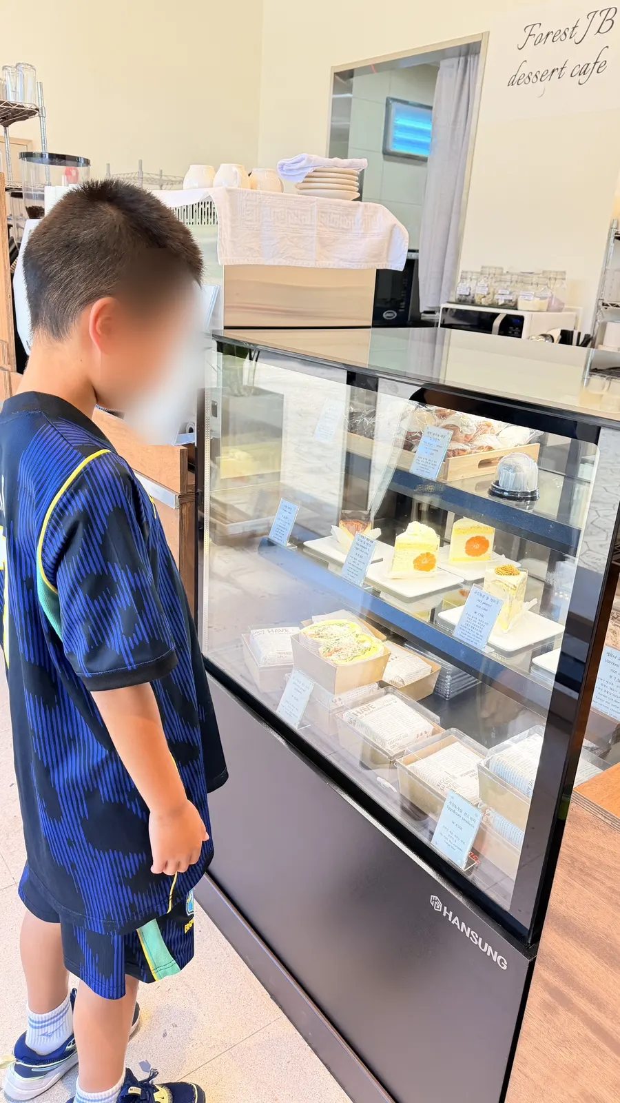 Dessert case with sandwiches, cookies, and cakes