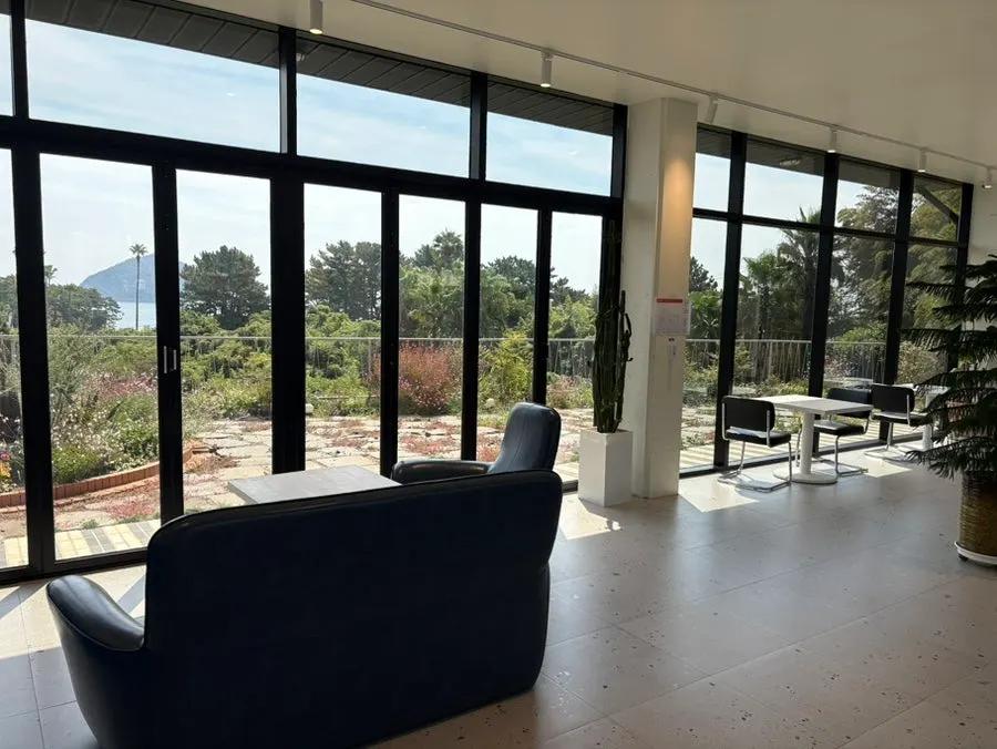 First-floor interior of Forest Jeongbang with floor-to-ceiling windows