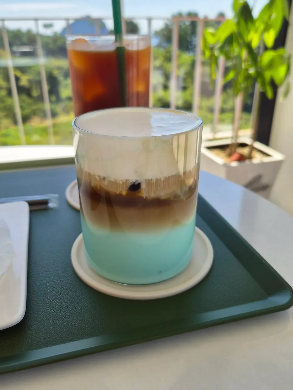 Jeongbang Waterfall latte placed on a window table