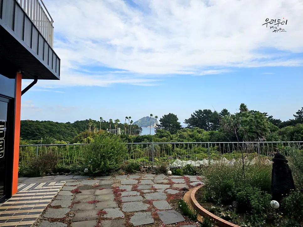 View of Seopseom Island and the Seogwipo sea between the buildings
