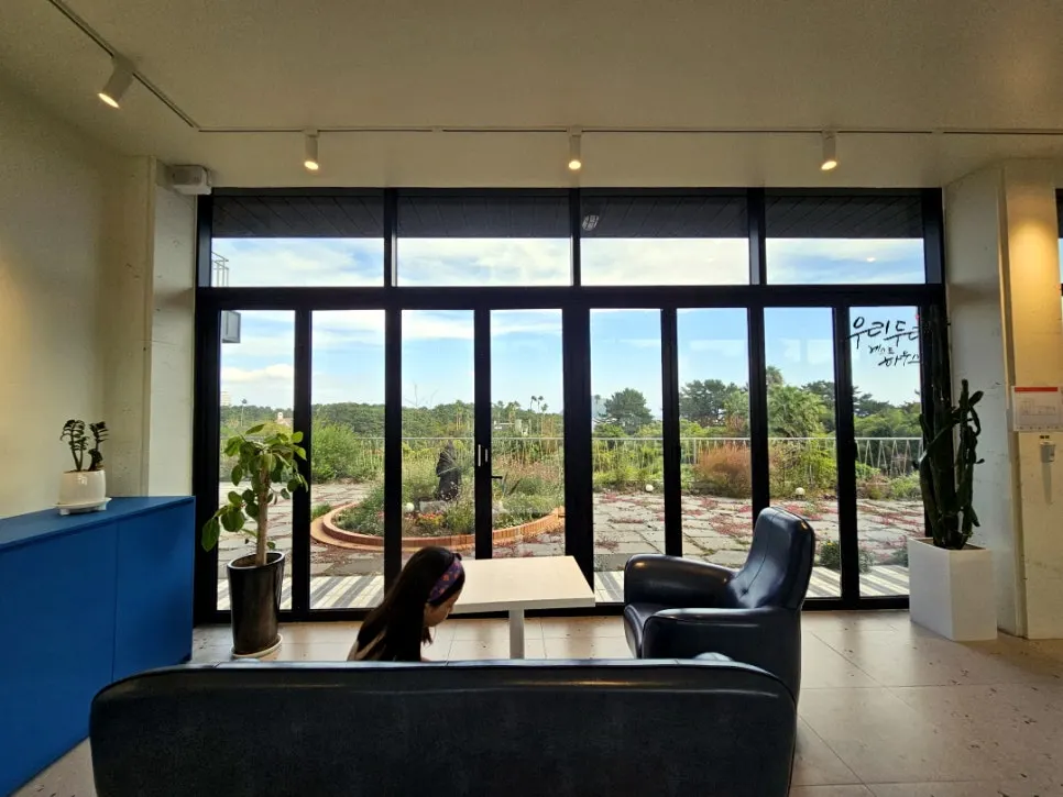 First floor window seat with a view of the Seogwipo sea through floor-to-ceiling windows