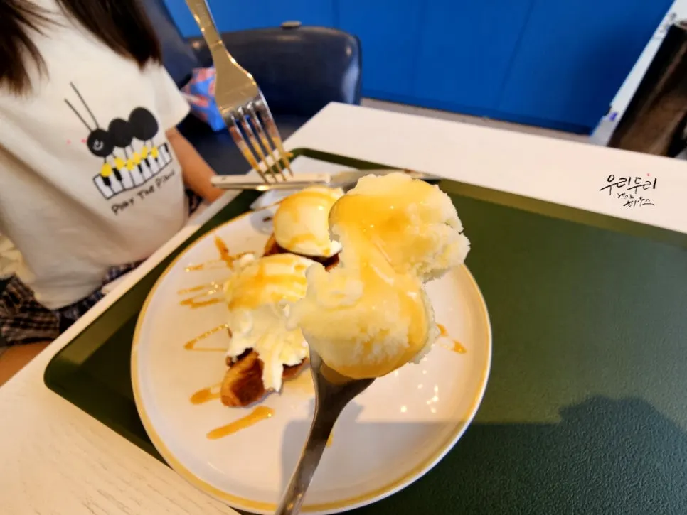 Ice cream croffle being sliced with a fork and knife