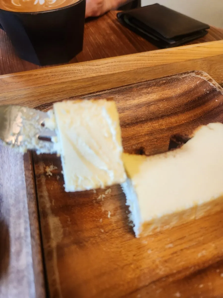 Cross-section of Basque cheesecake with a fork in it