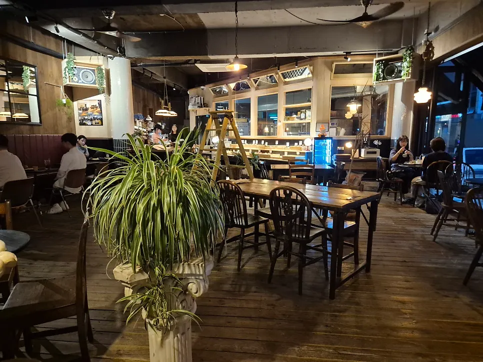 Exterior of Frank Coffee Bar with black signage and wood tones