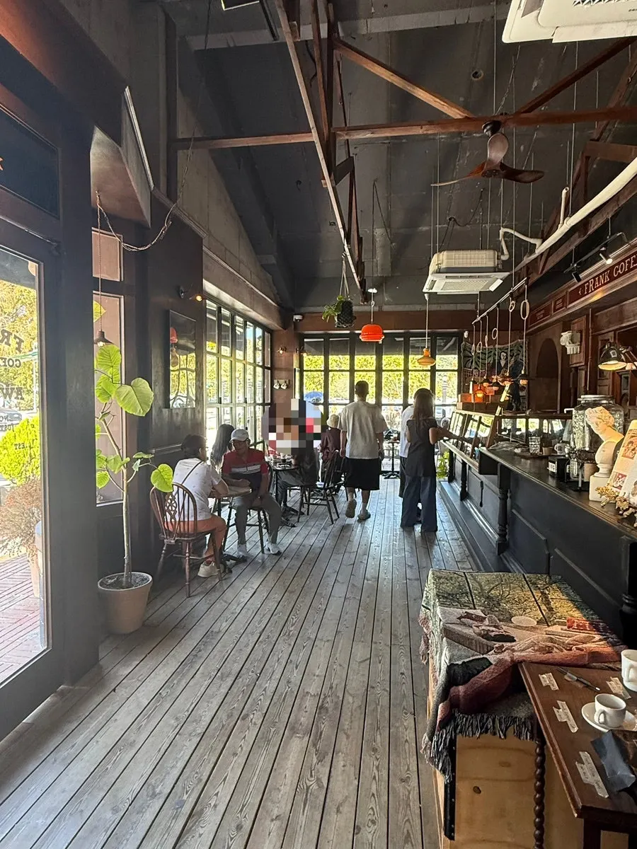 Indoor seating with sunlight streaming through the full glass windows