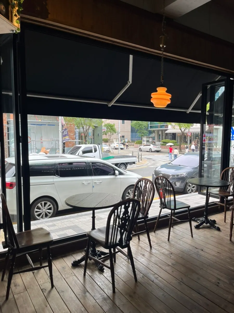 Seating beside the wide-open floor-to-ceiling window