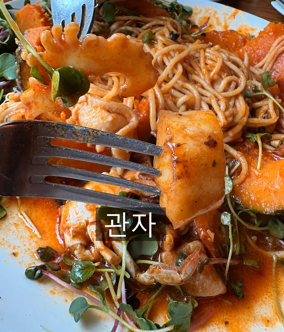 A bite of the tomato sauce pasta loaded with seafood