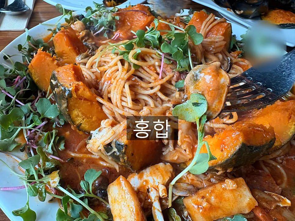 A plate of zuca dolce pasta loaded with seafood