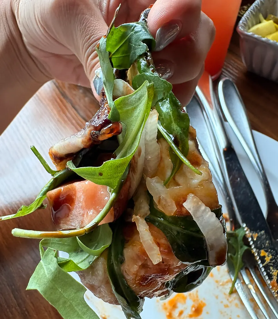 Thin-crust pizza folded in half to eat