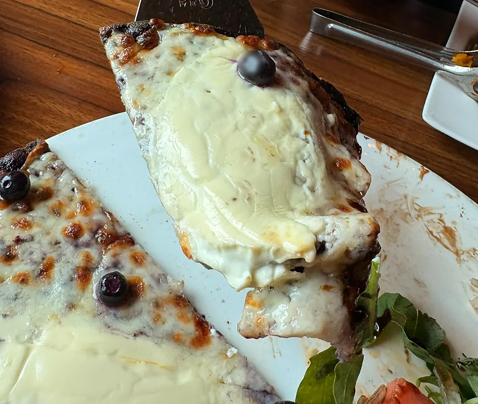 Half-and-half pizza topped with fresh arugula