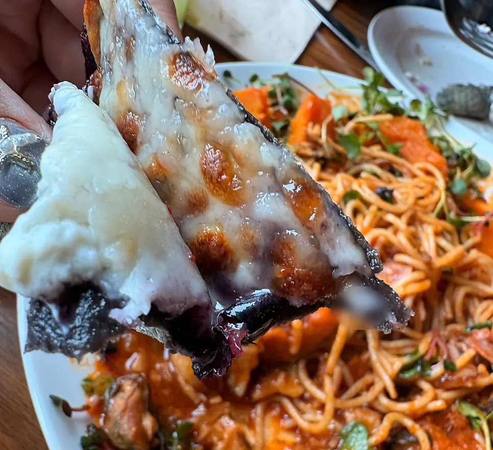 A slice of pizza with blueberry and cream cheese