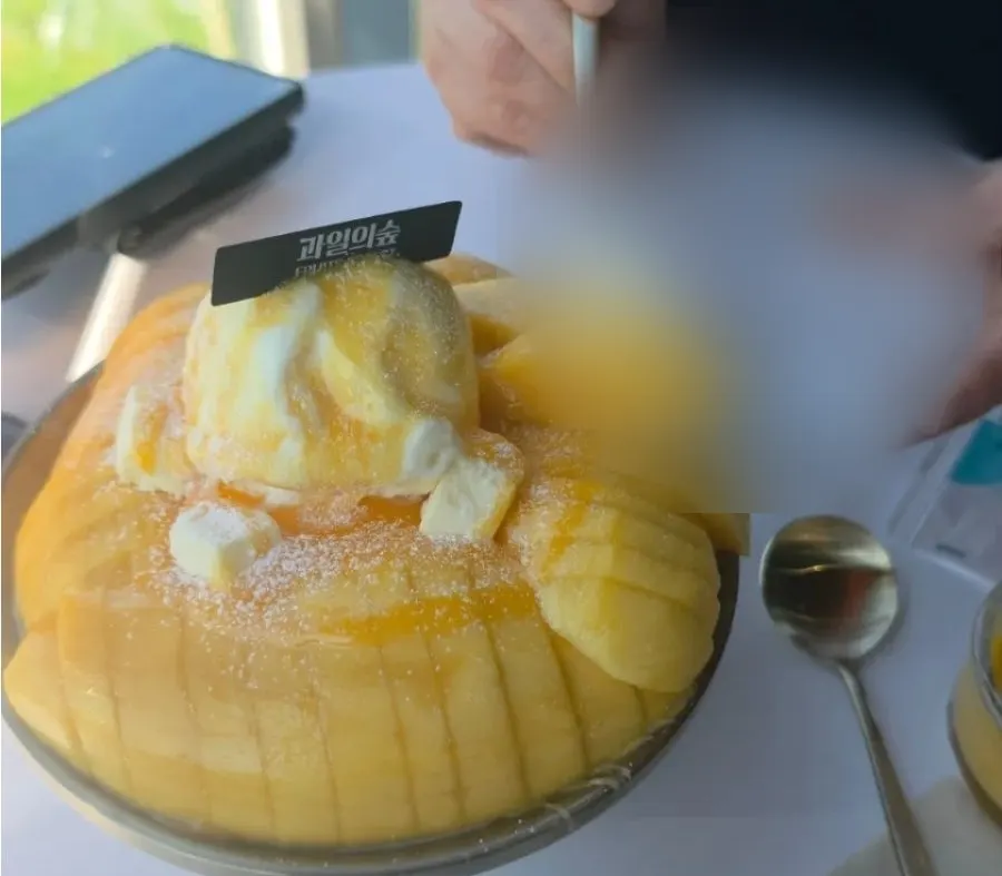 Fresh mango bingsu piled on snow ice