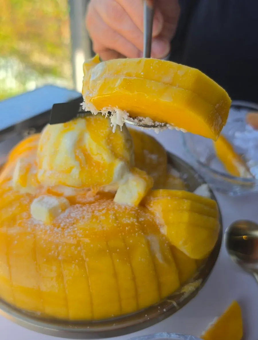 A spoonful of fresh mango snow bingsu