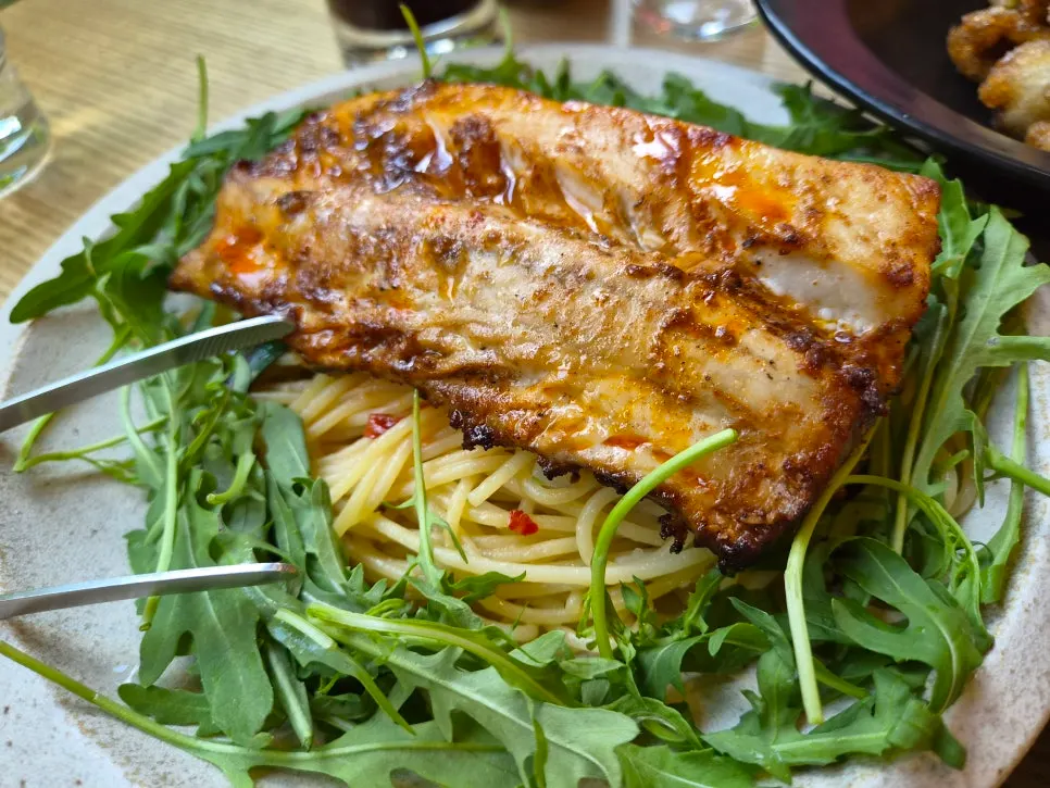 Mackerel pasta piled high with arugula