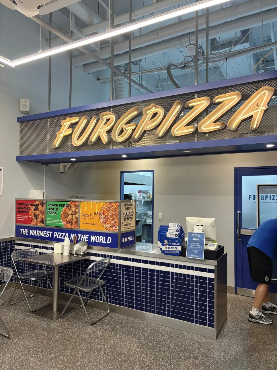 Sign noting American-style handmade pizza specialty