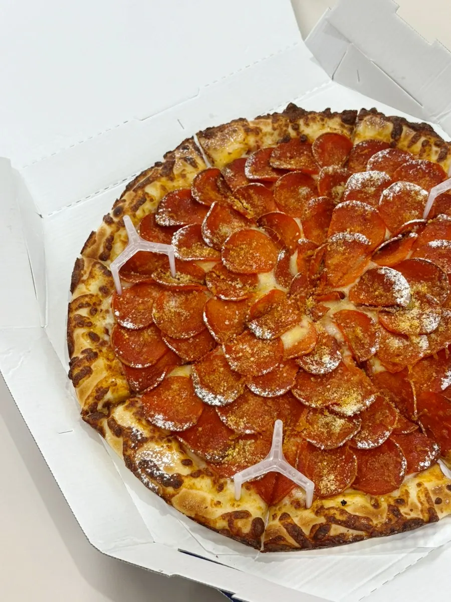 Double pepperoni pizza piled high with pepperoni