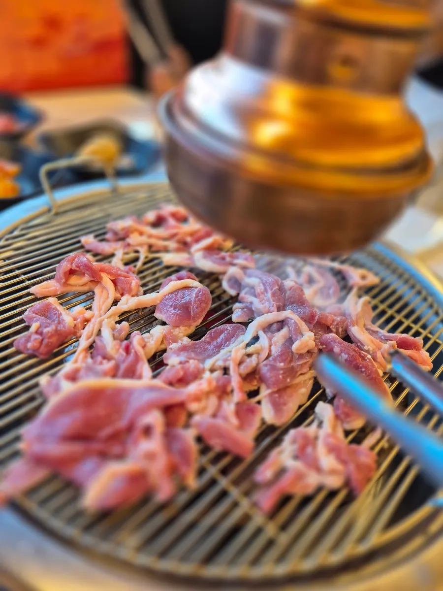 Raw duck grilling on the tabletop grill