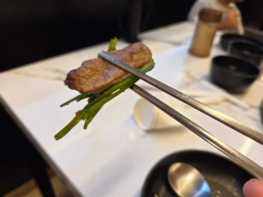 Dipping duck lightly in roasted salt