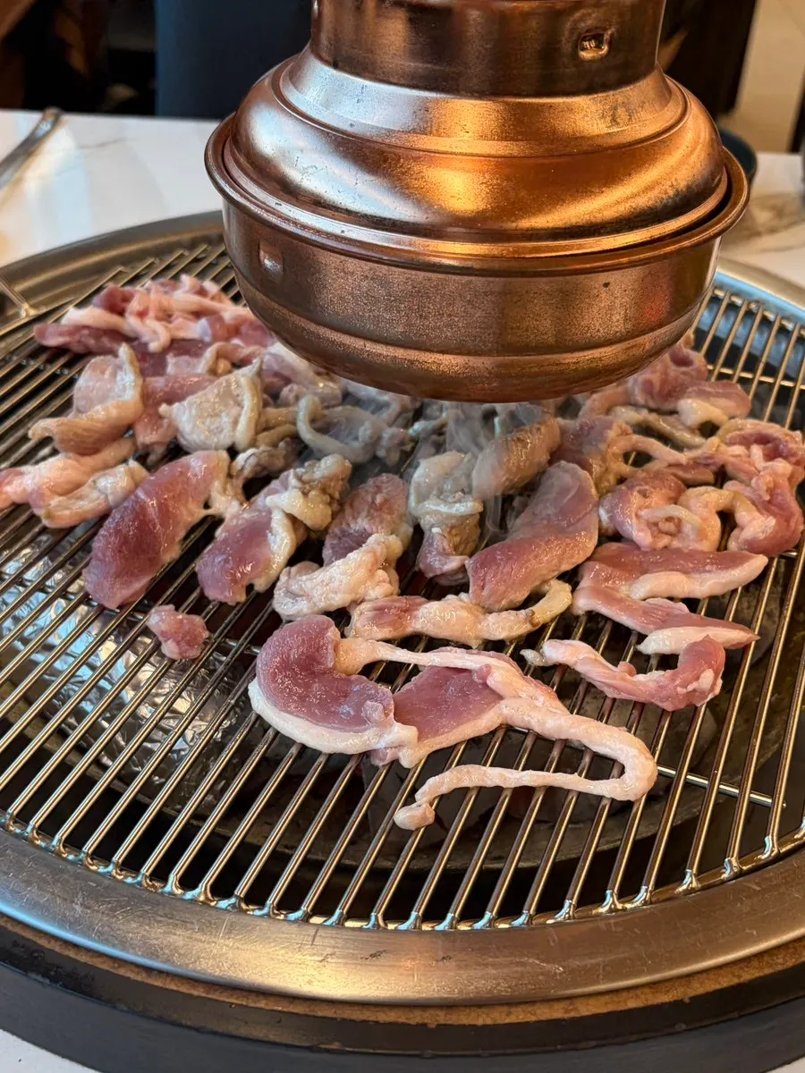 Raw duck grilling to a golden brown