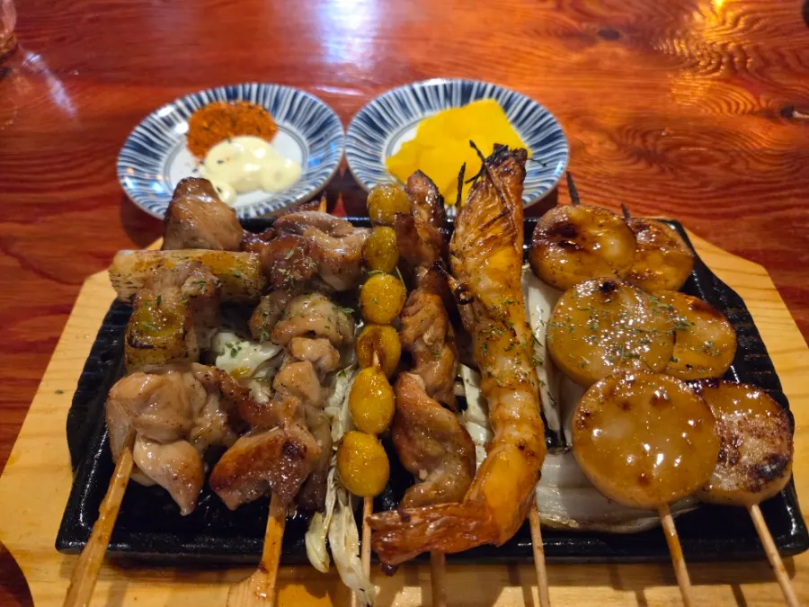 Grilled whole tofu kimchi and assorted skewers spread