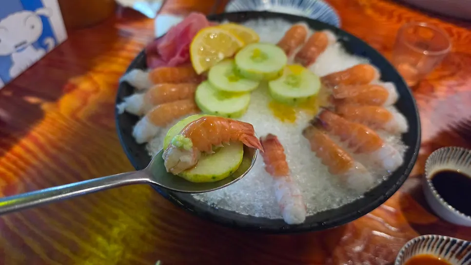 A bite of sesame-oil cucumber dipped in chogochujang sauce
