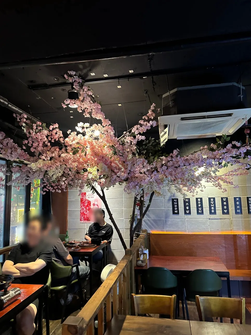 Pocha interior with cherry blossom decorations and warm lighting