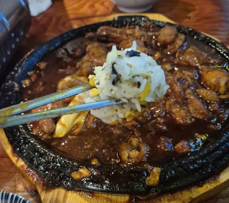 Rice ball dipped into fire-grilled cheese dakbal sauce