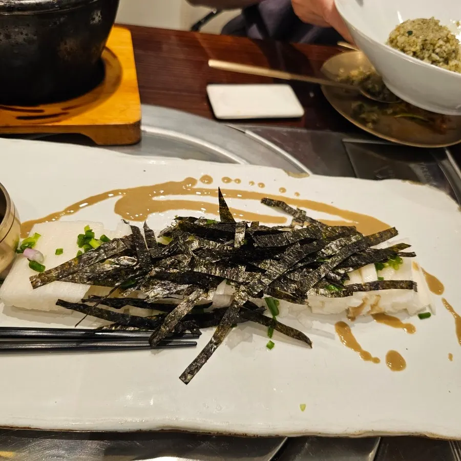 Julienned yam topped with seaweed flakes