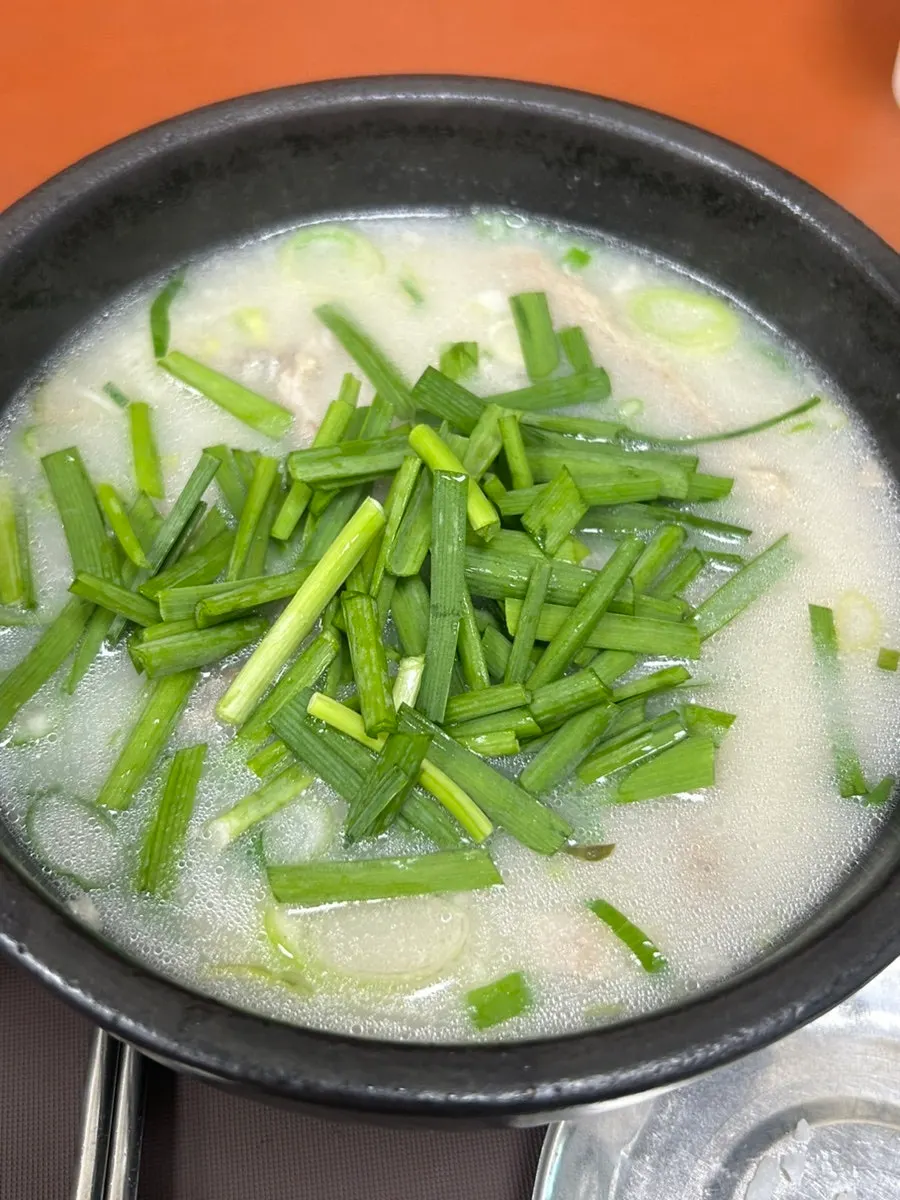 A piece of meat topped with salted shrimp from the soup